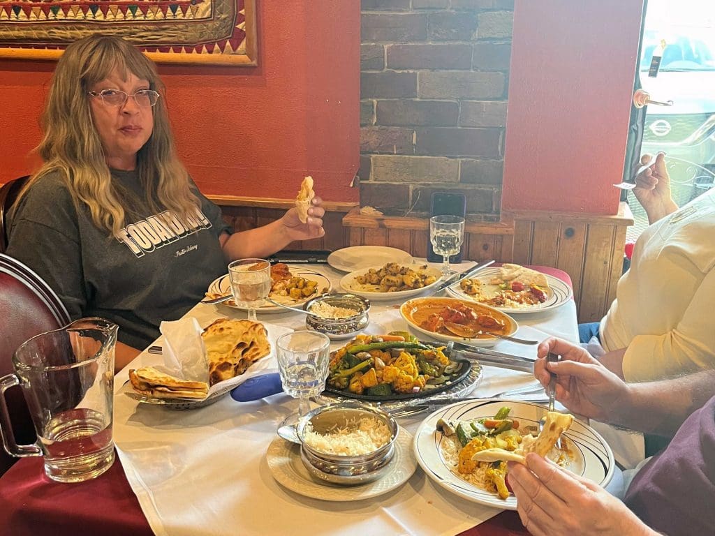 photo of woman and party eating at Taj Mahal